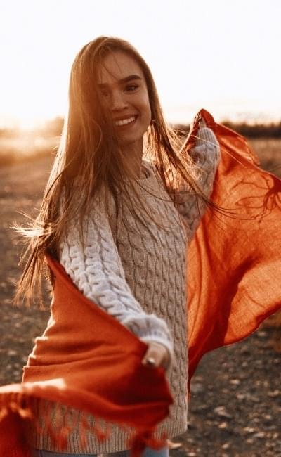 smiling girl with mantle around her